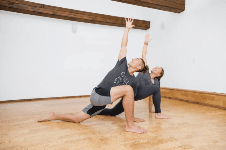 Two people practicing yoga