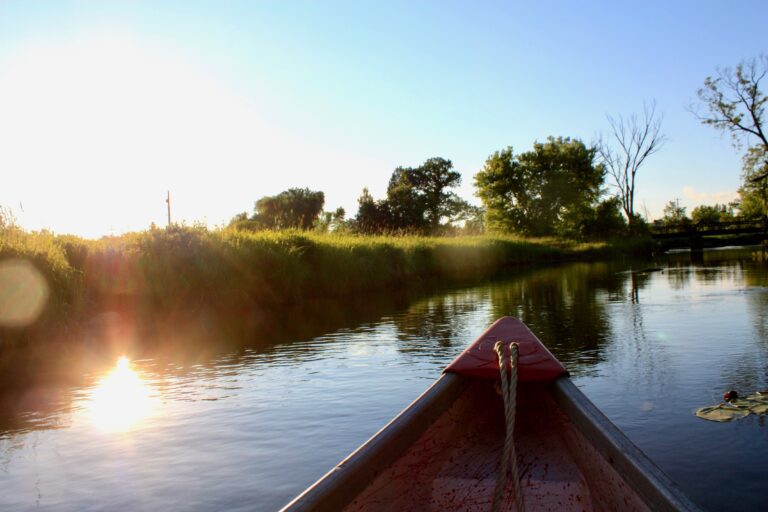 View of the bow of a canoe, from inside the canoe, on a lake