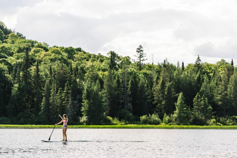 Person paddling on a standup paddle board on a lake
