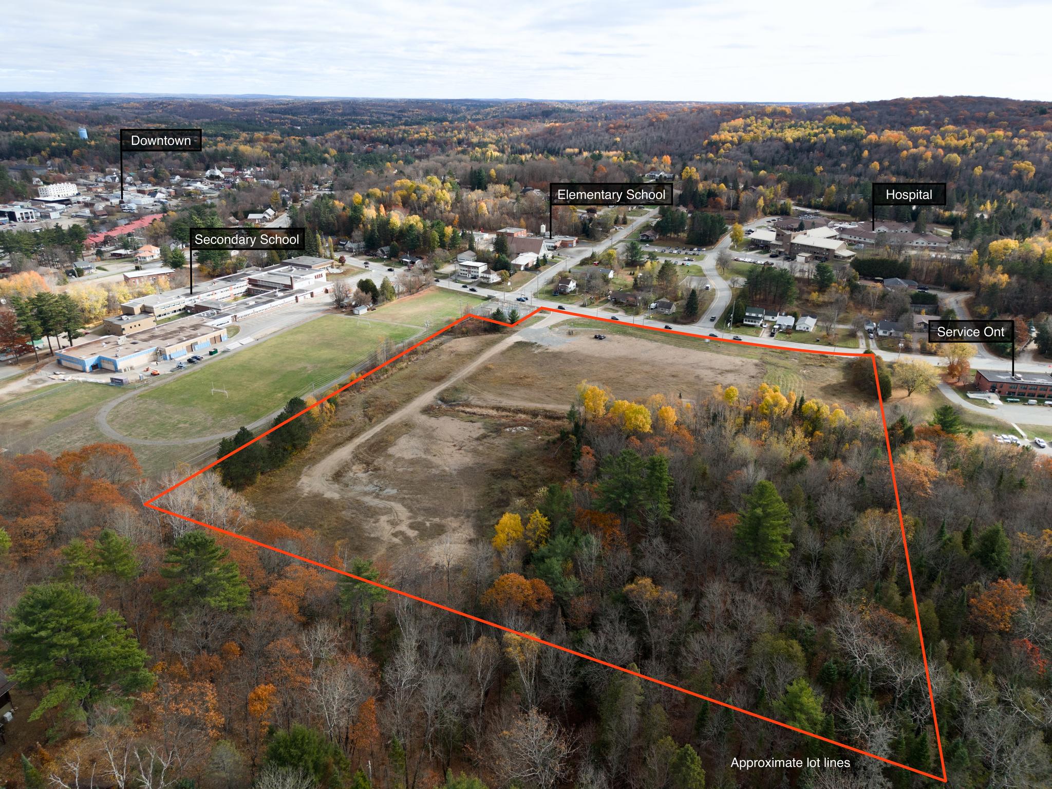 Vacant lot with red rectangle around it. Flags for School, Downtown, Hospital in the distance to show its close proximity. 