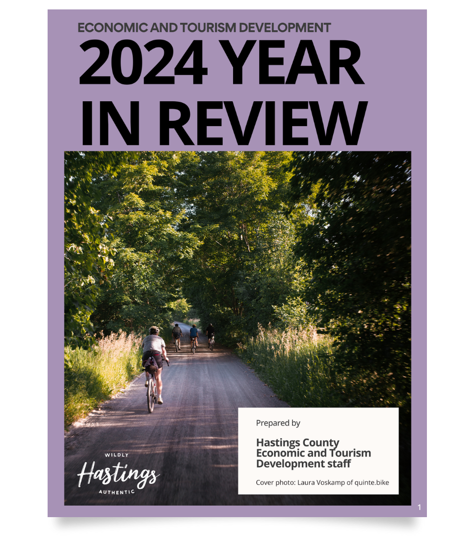 2024 Economic Development and Tourism Year In Review. Front cover of 2024 Year In Review with picture of person cycling on a road on a purple background. 