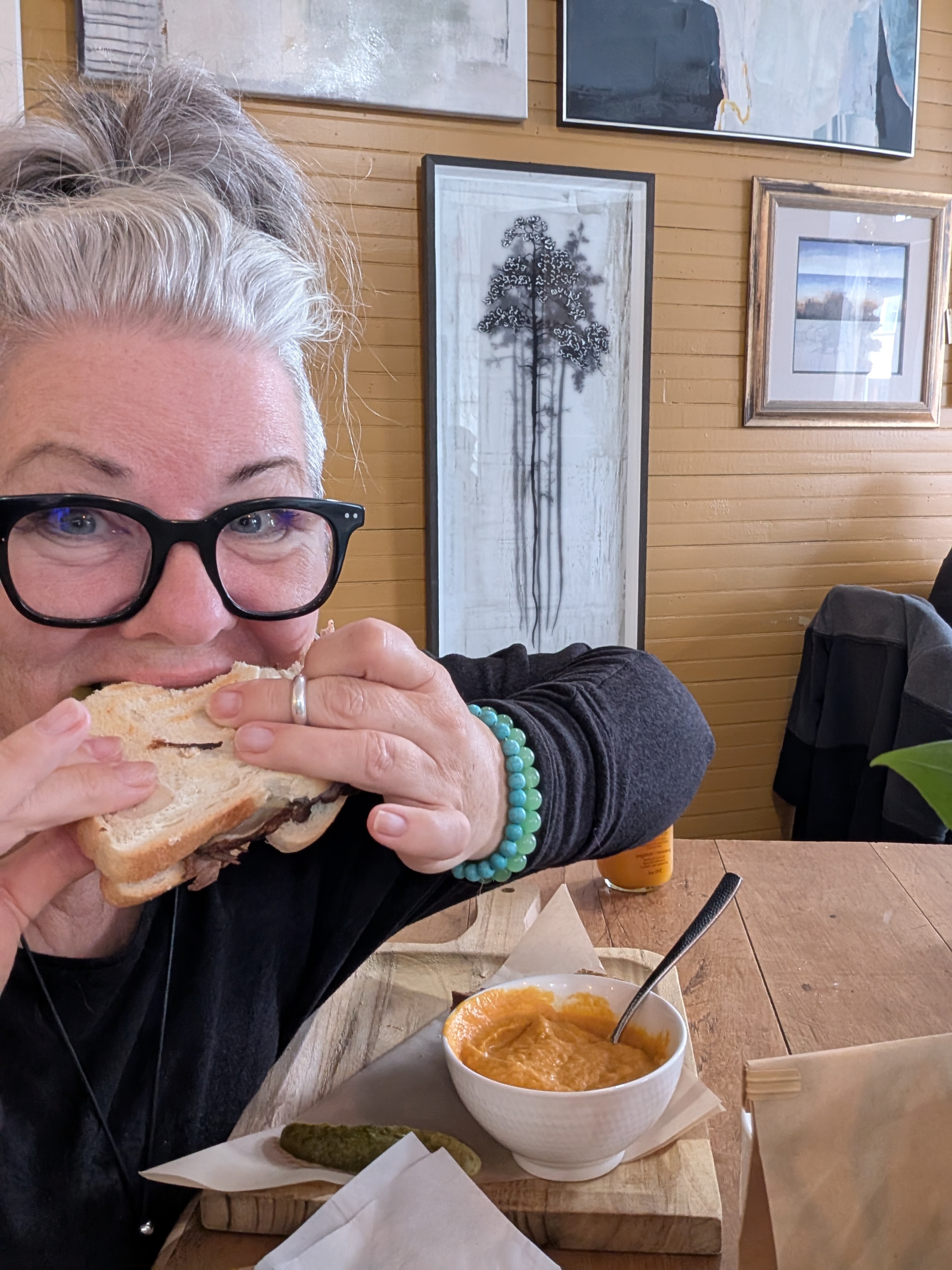 Woman eating sandwich and soup at Farm Girl