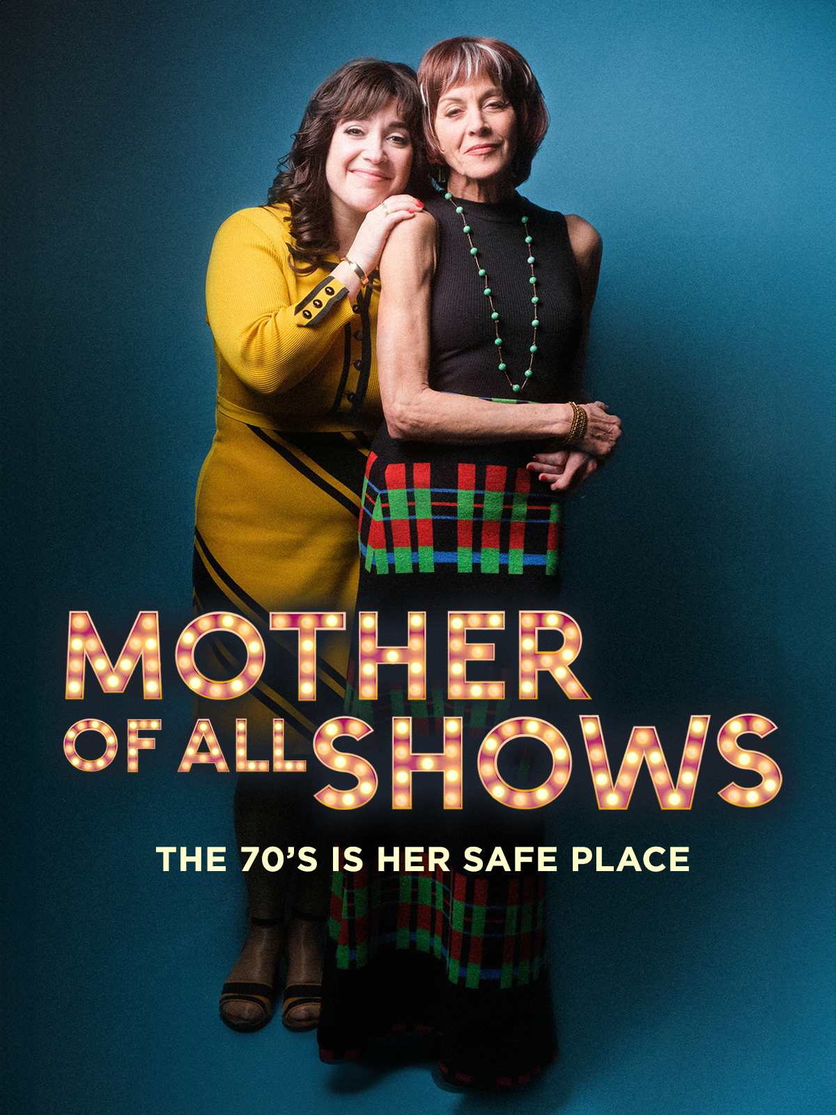 The Mother of All Shows Poster. Two people standing together with a blue background. 