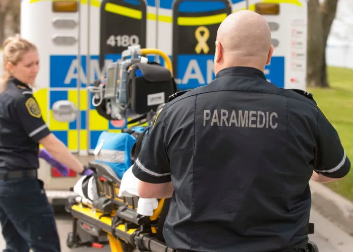 Photo of paramedics loading into ambulance
