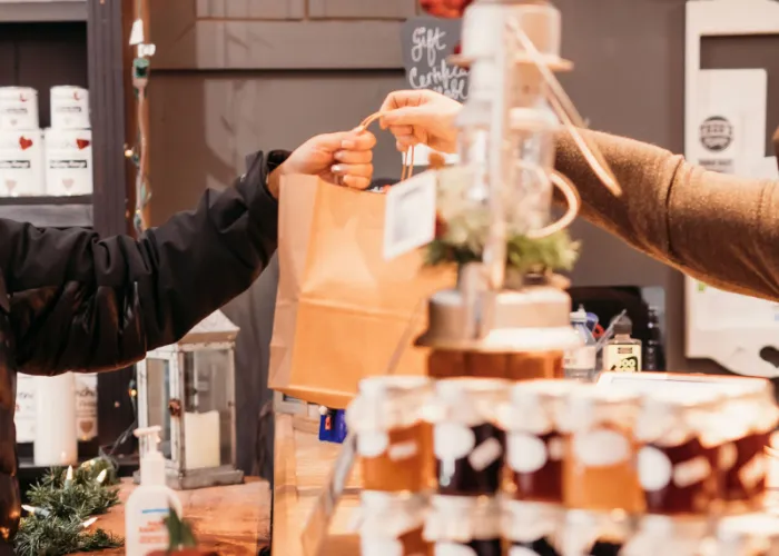 Person handing a bag to a customer