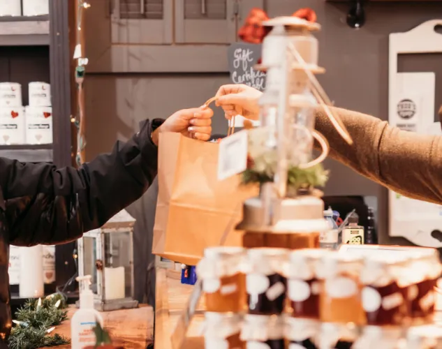 Person handing a bag to a customer