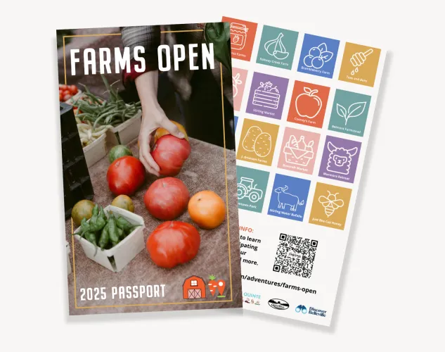Farms Open Passport Book. Two pages are shown one is the cover of the booklet with a hand picking up a tomato. The other page has colourful squares with icons representing different farms for people to mark off as they visit locations. 